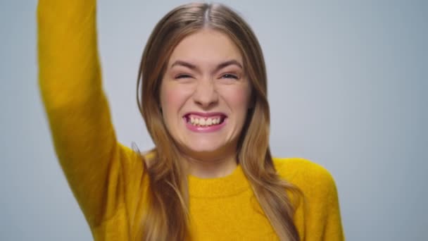 Портрет щасливої привабливої жінки, що показує так жест на сірому фоні . — стокове відео