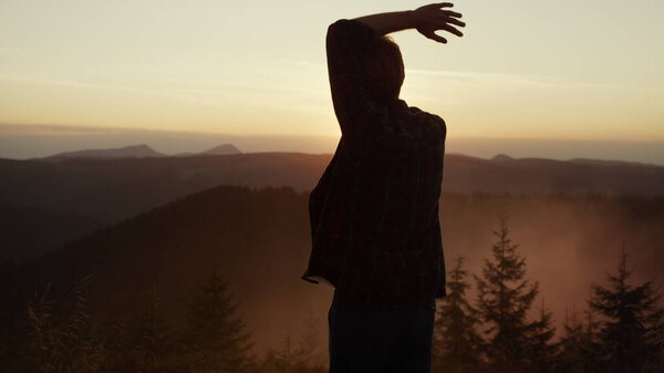 Guy dancing in natural landscape. Smiling man making funny moves during dance