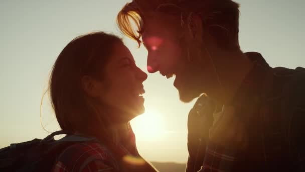 Портрет щасливої жінки і чоловіка, дивлячись один на одного в горах заходу сонця — стокове відео
