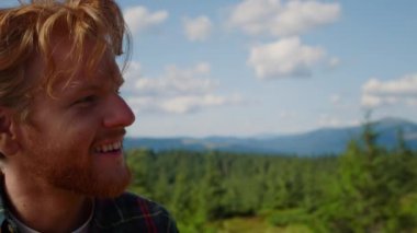 Dijital kameralı olumlu bir adamın portresi dağların fotoğraflarını çekiyor.