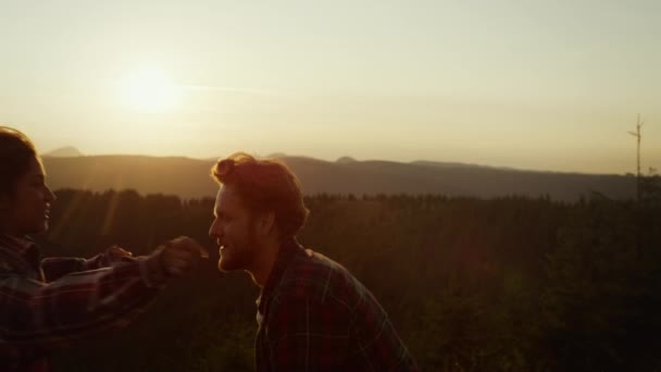 Smiling guy spinning girl on hands. Happy couple embracing together — Stock Video