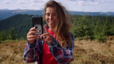 Yürüyüş yapan bir kadın arkadaşla akıllı telefondan görüntülü konuşma yapıyor.