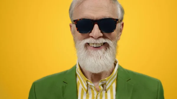 Fröhlicher Mann, der drinnen in die Kamera lächelt. Stilvoll alt kerl posieren im studio. — Stockfoto