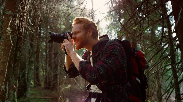 Turysta strzelanie zielony krajobraz w lesie. Fotograf za pomocą aparatu fotograficznego — Zdjęcie stockowe
