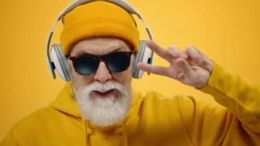 İçeride kulaklıkla müzik dinleyen neşeli yaşlı bir adam. Olgun adam içeride dans ediyor..