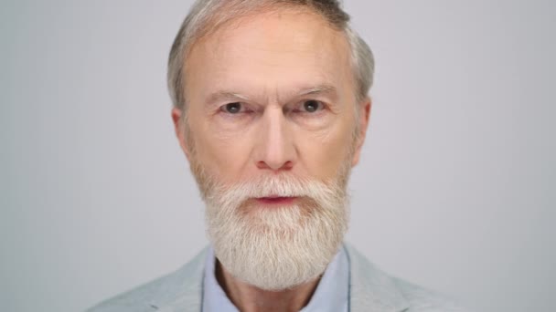 Un uomo sorridente che muove le sopracciglia in studio. maturo maschio modello posa per fotocamera. — Video Stock