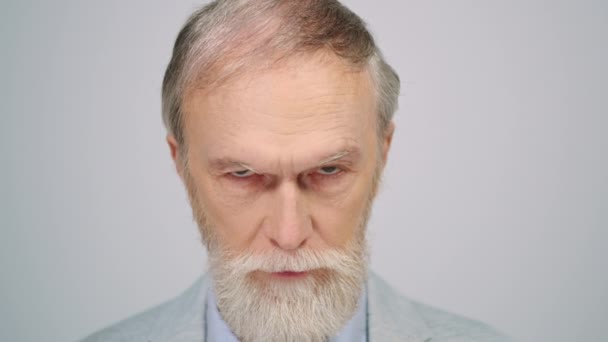 Old man posing at studio. Portrait of handsome pensioner looking camera indoors. — Stock Video