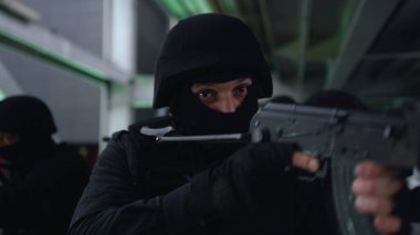 Maskeli askerler tüfeklere nişan alıyor. SWAT ekibi köprüyü araştırıyor. 