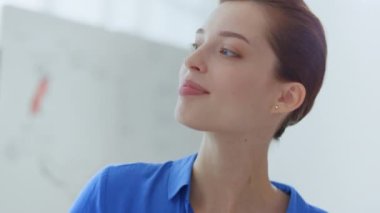 Beyaz yönetim kurulu ofisi görünümlü bir iş kadını. Kadın akıl hocası içeride insanlarla konuşuyor.