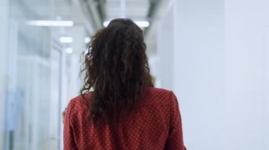 Afrikalı bir kız cep telefonuyla konuşuyor. Arkaya bakan kadın gülümseyen meslektaşım 