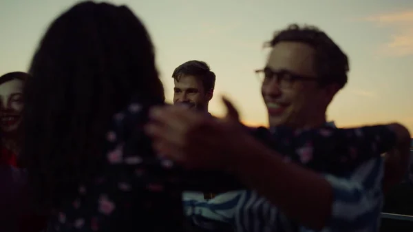 Vrienden knuffelen terwijl ze elkaar ontmoeten op het feest. Mensen die elkaar high five geven. — Stockfoto