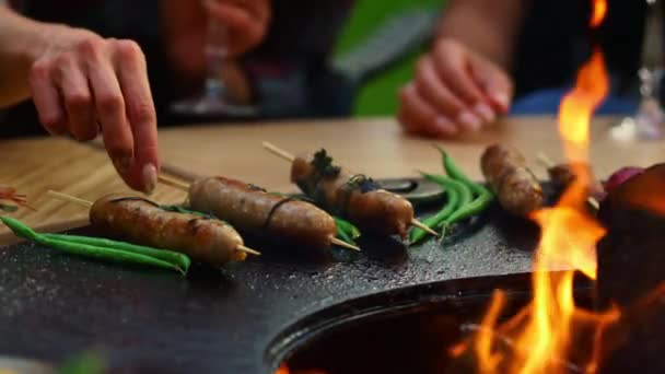 Unknown woman turning sausages outside. Woman cooking for bbq party outdoors — Stock Video