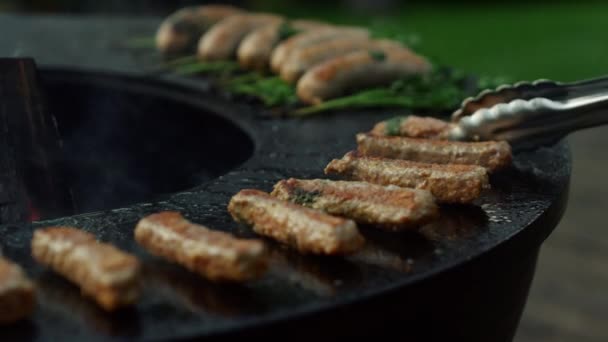 Meat kebab grilling for party. Meat sticks browning outside on backyard. — Stock Video