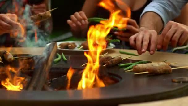 Unknown people grilling meat and vegetables outdoors. Friends cooking outside — Stock Video