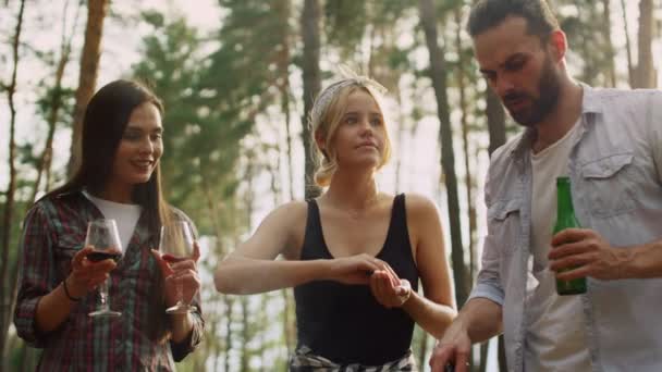 Focused friends cooking food together outside. Smiling woman keeping salt — Stock Video