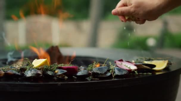 Man knijpt citroen op zeevruchten op grill. Chef koken mosselen op rang — Stockvideo