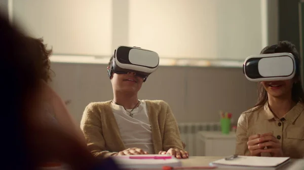 Pupils using vr glasses in classroom. Students immersing in virtual reality