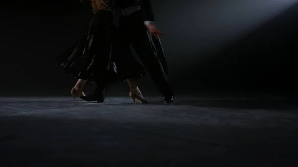 Closeup dancers feet performing valse indoors. Unknown man and woman dancing.