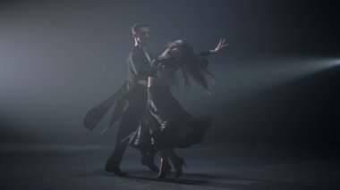 Salon dansçıları içeride gösteri yapıyor. Güzel dans çifti sahnede dönüyor..