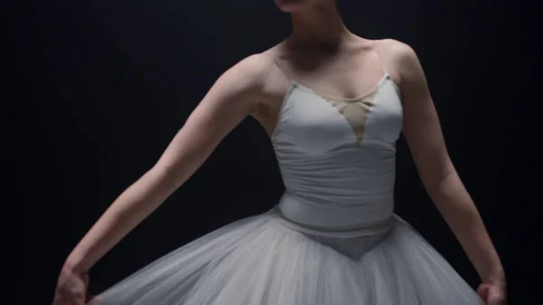 Tender ballerina touching hands tutu skirt indoors. Ballet dancer dancing inside — Stock Photo, Image