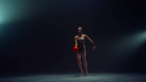 Mooie vrouw die binnen aan het sporten is met bal. Gymnast doet aan calisthenics. — Stockfoto