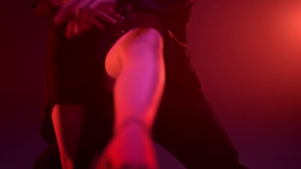 Невідома пара ніг танцює в темному залі. Чуттєві танцюристи роблять підтримку в приміщенні . — стокове відео