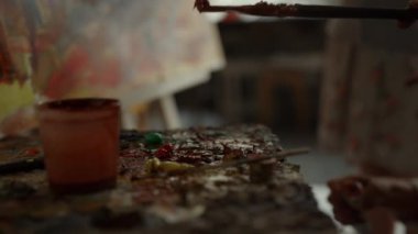 Bilinmeyen ressam eli içeride fırça darbesi yapıyor. Stüdyoda resim yapanlar.