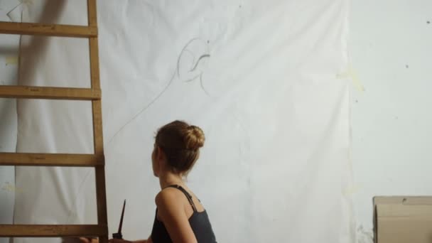 Inspired woman working in art studio. Creative painter making draft on canvas. — Stock Video