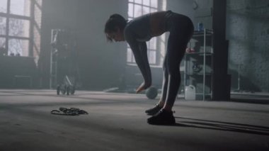 Eğitimden önce esneme egzersizleri yapan bir kız. Spor salonunda vücudu ısıtan kadın.