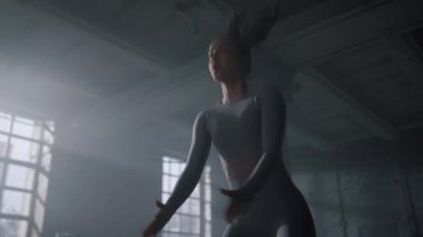 Sporcu kadın yüksek atlama ile çömelme yapıyor. Sporcu yoğun antrenman yapıyor. 