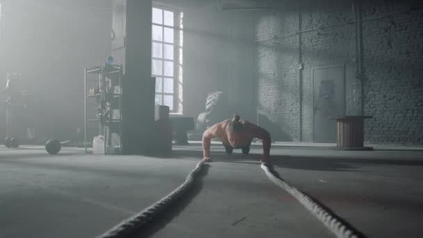 Athlete doing push ups in gym. Man making fitness training in loft building — Stock Video
