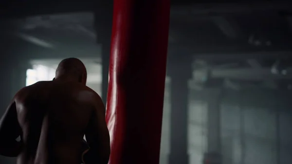 Male kickboxer fighting with punch bag. Guy preparing for fight competition — Stock Photo, Image