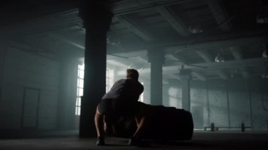 Lastik lastikle egzersiz yapmaya hazırlanan bir sporcu. Lastik patlatan adam.