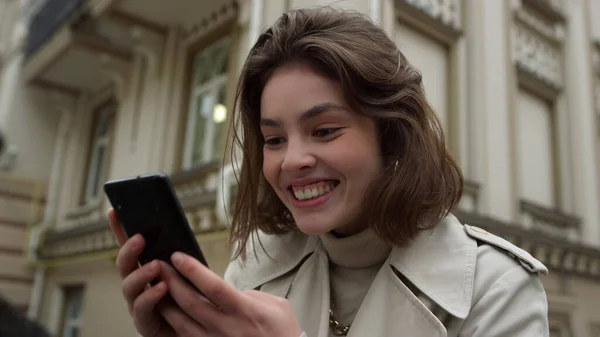 Mulher excitada fazendo videochamada na cidade. Menina feliz usando câmera de telefone ao ar livre. — Fotografia de Stock
