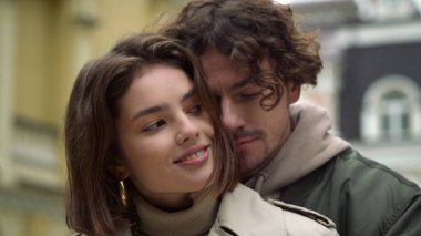 Şehir merkezinde sevgi dolu bir çift sarılıyor. Şehir sokağında çıkan kız ve erkek..