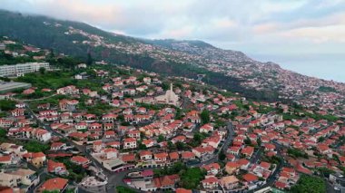 Yeşil dağ manzaralı, havadan sakin köy kıyıları. Güzel deniz manzarası. İnsansız hava aracı, yaz mevsiminde deniz kenarındaki evleri vurdu. Bulutlu bir günde, bereketli ada pelerinindeki manzara gezisi kasabası