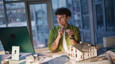 Bina tasarımcısı düşünme projesi ofis işyerindeki bilgisayara yakından bakıyor. Ev tasarımı üzerine çalışan ciddi profesyonel bir mimar. Mühendislik uzmanı konut inşaatı planlıyor..