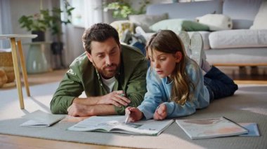 Kafası karışmış baba kız evde çalışıyor zor okul problemlerini birlikte ders kitabı okuyarak çözüyor. Liseli kız babasından, oturma odasında yerde yatarak ödev yapmak için yardım istiyor. Eğitim sorunu.