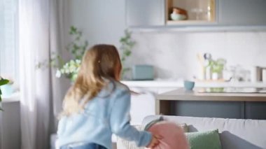 Neşeli kız yastıklarla savaşıyor gülümseyen baba aydınlık oturma odasında. Şakacı sakallı baba, eğlenceli bir oyun oynuyor ve hafta sonu evde eğleniyor. Mutlu aile eğlencesi. Ebeveyn ilişkisi aşkı.