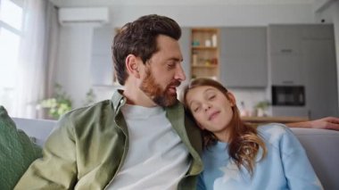 Pov videolu baba kızı, konforlu daire kanepesini birbirine yakın çekimde görüntülüyor. Gülümseyen genç kız el sallıyor dijital cihaz web kamerası çevrimiçi toplantıda konuşuyor oturma odasında kanepede oturuyor..