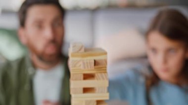 Baba kız masa oyunu oynuyor. Boş zamanlarını aile oturma odasını kapatarak geçiriyor. Odaklanmış ergen, havlunun dengesini bozuyor. Sakallı baba, kızı destekliyor, Jenga 'nın keyfini çıkarıyor..