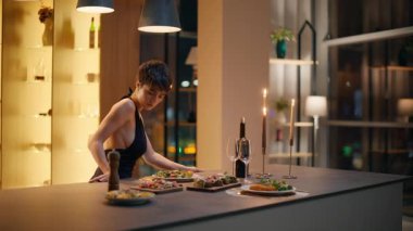 Sakin bir bayan servis masasında bekliyor. Zarif, kısa saçlı, panoramik pencereli bir kadın mum ışığında gece manzaralı bir yer. Harika bir manken kokteyl elbisesi giyiyor.