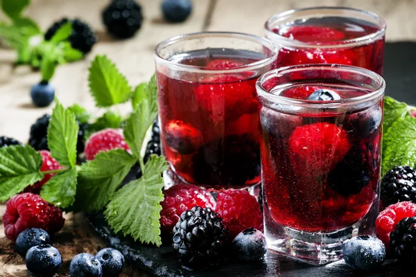 Cold summer berry tea with raspberries, blueberries, blackberries and mint