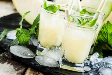 Cool summer juice of melon with ice and mint