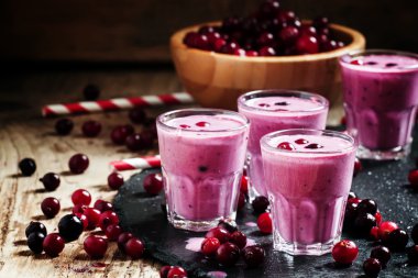 Pink smoothies with milk, black currants and cranberries
