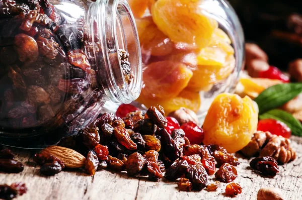 Dry dark raisins in a glass jar — 图库照片