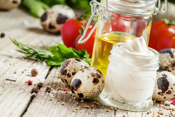 Mayonnaise sauce with quail eggs in a glass jar — Stockfoto