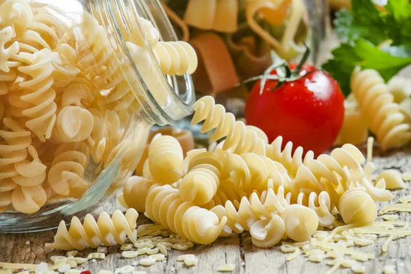 Dry Italian pasta spiraline in glass jars — стокове фото