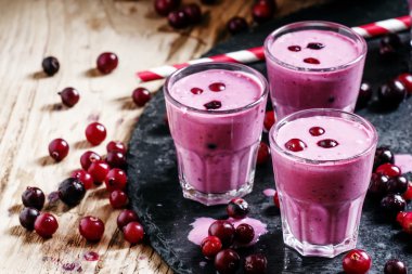 Pink smoothies with milk, black currants and cranberries