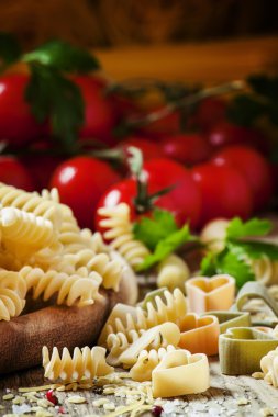 Italian food: pasta spiraline, herbs, tomatoes